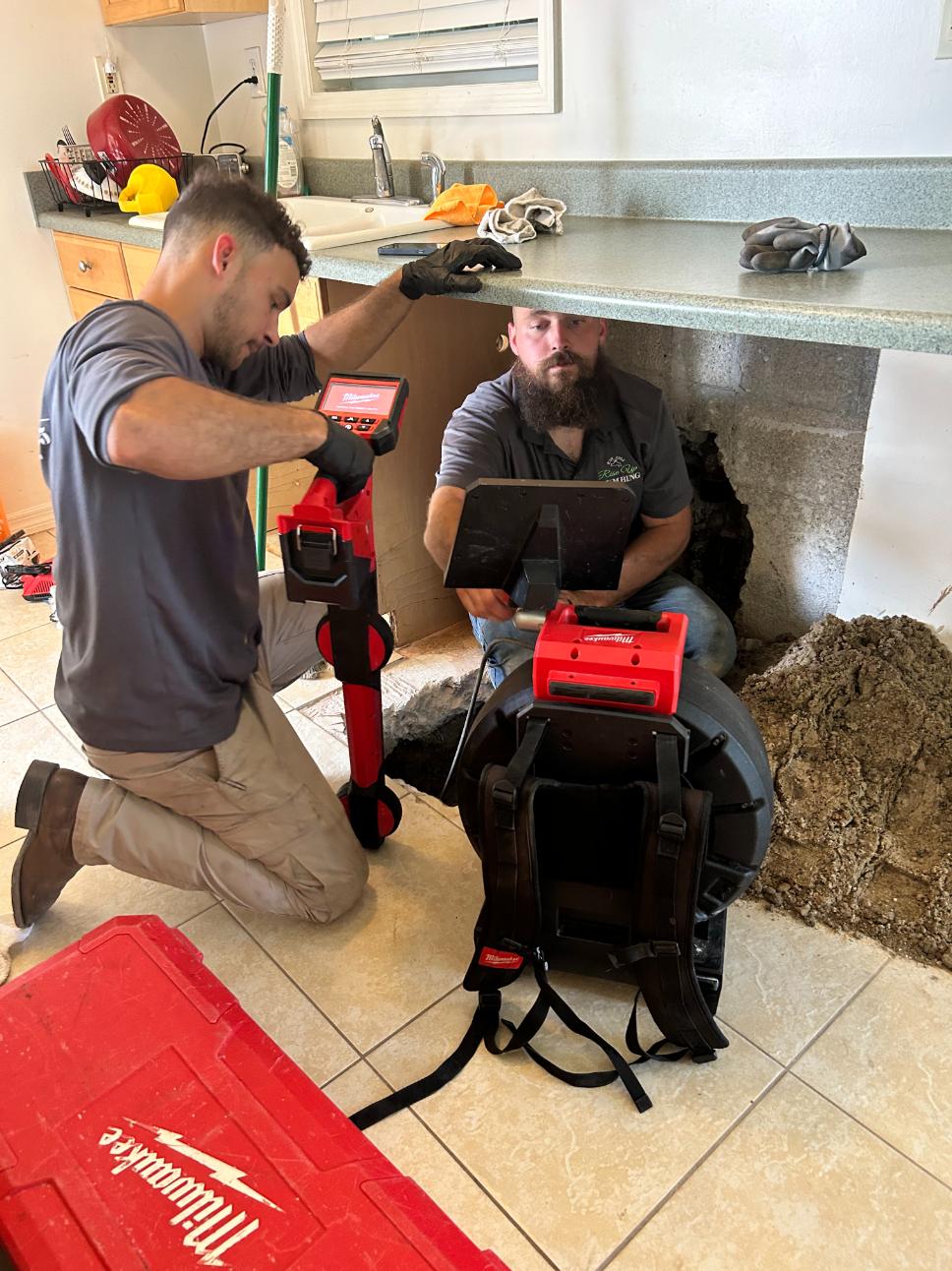 plumbers fixing a residential plumbing issue