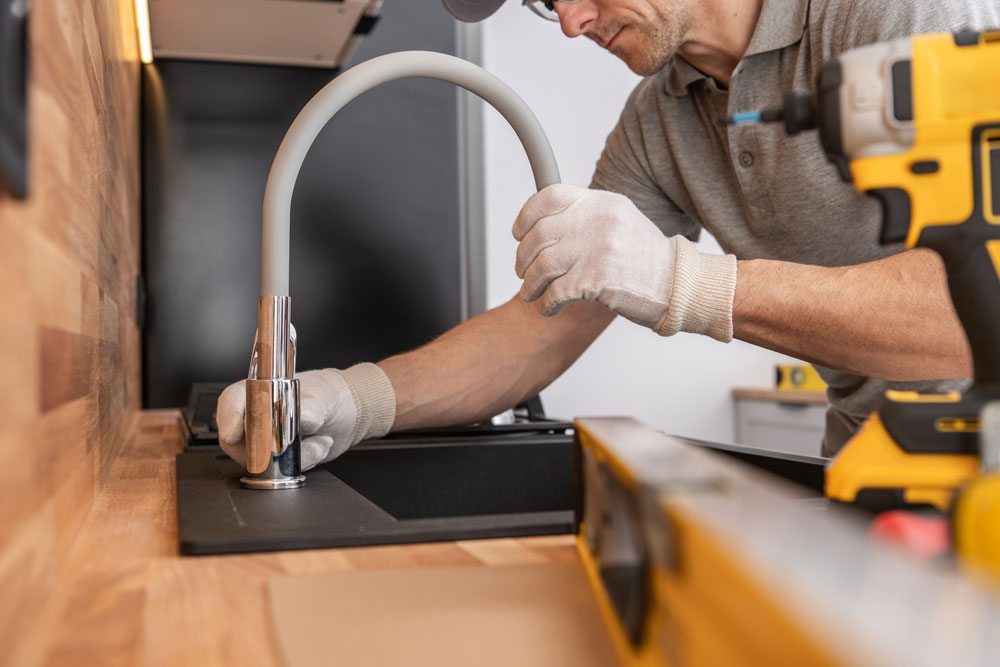 Plumber fixing a leaking faucet in a florida home