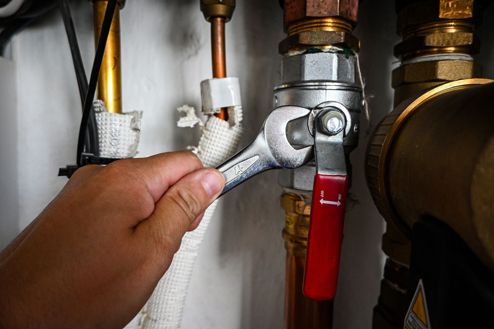 Plumber fixing a plumbing issue in a home